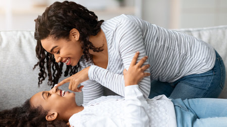 Loving black mother and daughter having fun togetherの写真素材