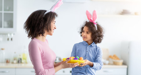 Black girl and lady wearing bunny ears on Easter day
