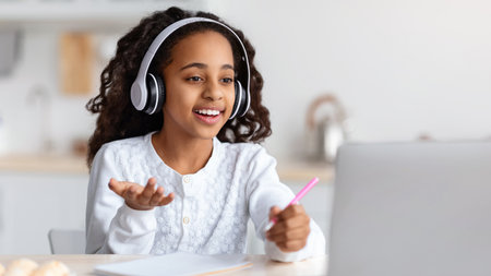 Joyful african american girl having online lesson from home