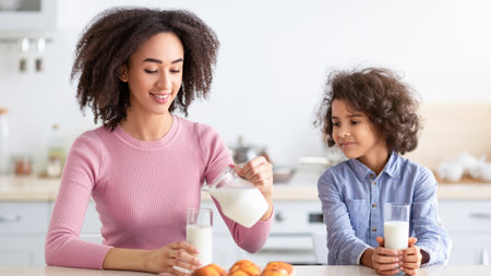 Little Black Girl And Woman Drinking Milkの写真素材