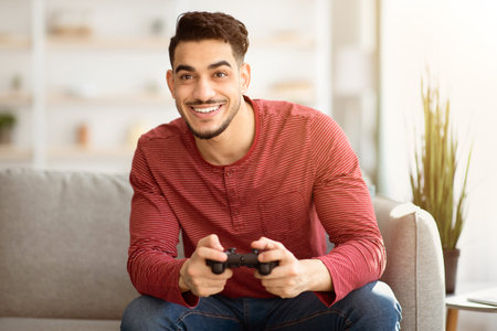 Young arab man playing video games at home