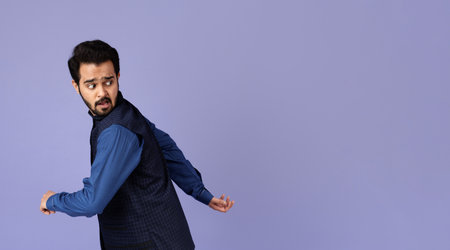 Scared Indian man running away from something on lilac background, copy space. Panorama