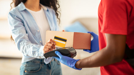 Portrait of black man holding POS machine for payment