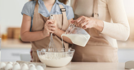 Lady and her granddaughter kneading dough, closeup