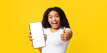 Thumbs-up gesture. Overjoyed african american lady showing like sign, yellow background, panorama...