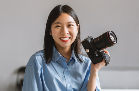Portrait Of Smiling Asian Woman Holding Photo Camera Posing
