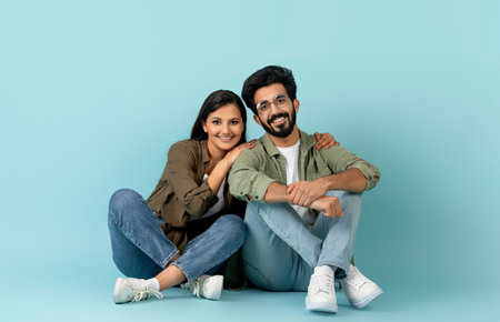 Beautiful multicultural young couple bonding on blueの写真素材