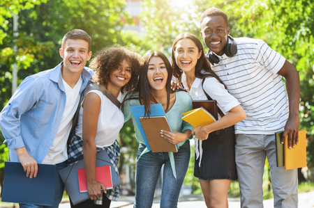 Portrait Of Cheerful International Students Posing Together While Having Fun Outdoors