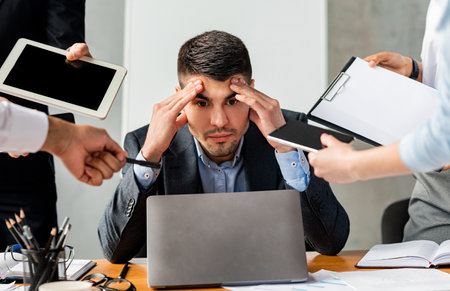 Stressed Businessman Tired Of Tasks Sitting At Work In Office