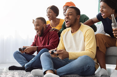 Emotional african american friends playing video games at home