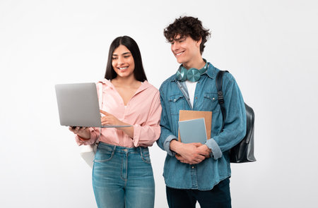 Cheerful Students Couple Using Laptop For Education Over White Background