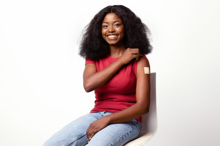 Vaccination Campaign. Joyful African American Lady Demonstrating Arm With Adhesive Bandage