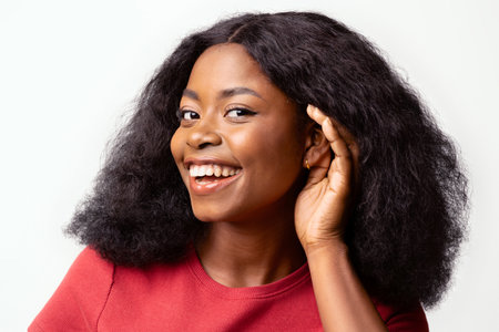 Curious Cheerful Black Woman With Hand Near Ear Trying To Overhear Something