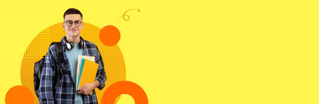 Student stands confidently with books in modern classroom settingの写真素材