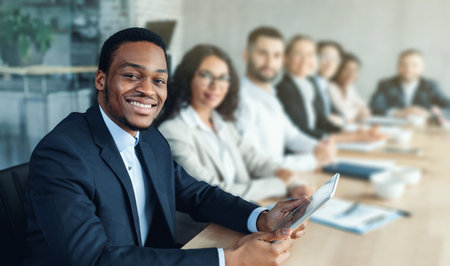 African Businessman On Corporate Meeting With Colleagues Sitting In Officeの写真素材