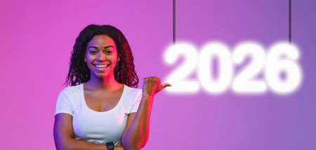 Smiling Black Lady Pointing at Copy Space With Excitement in Vibrant Neon Lights