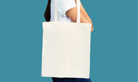 Girl Holding White Eco Bag Standing In Studio, Panorama, Croppedの写真素材