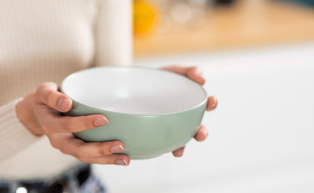 Unrecognizable woman holding empty bowl in her handsの写真素材