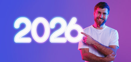 Man Poses With Finger Pointing at Copy Space in Vibrant Studio Lightingの写真素材