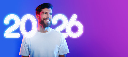 Modern Man in Neon Studio Lights Poses for Fashion Promotion in Vibrant Colors
