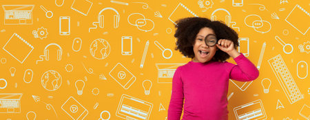 Child in a Pink Shirt Playfully Holds a Magnifying Glass in a School-Themed Settingの写真素材