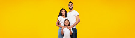Arabic Family Hugging Standing Posing Together Over Yellow Backgroundの写真素材