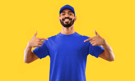 Middle Eastern Male Delivery Worker Pointing Fingers At Himself, Studio Shotの写真素材