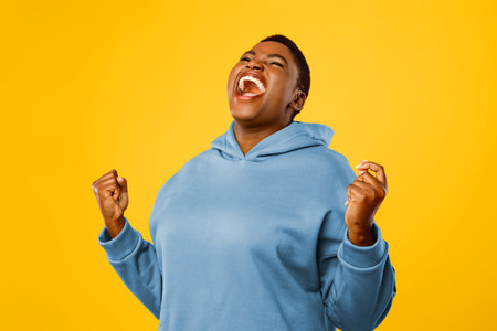 Emotional Plus-Size African American Woman Shouting Gesturing Yes Over Pink Background
