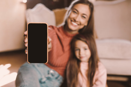 Family showing blank empty smartphone screen for mockupの写真素材