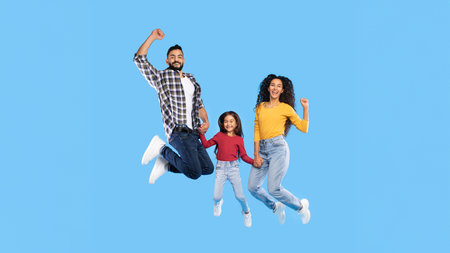 Cheerful Middle Eastern Family Of Three Jumping Over Blue Background