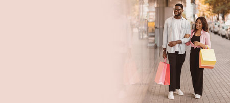 Beautiful black couple walking with shopping bagsの写真素材