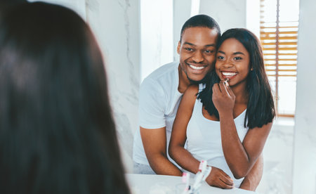Happy Black Couple Spending Time Together In Bathroom In The Morningの写真素材