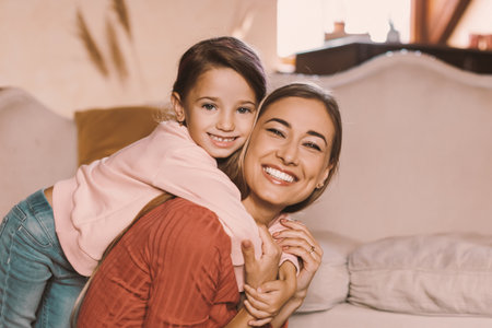 Portrait of happy young woman and daughter spending time togetherの写真素材