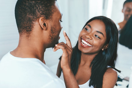 Caring Black Female Applying Moisturising Cream On Boyfriends Face In Bathroom,の写真素材
