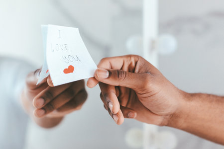 Male Hand Putting Sticky Note With I Love You Text On Mirror