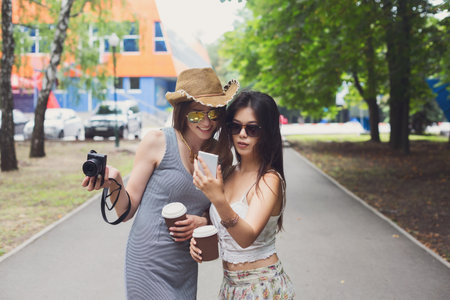 Outdoor portrait of three friends take selfie with smartphoneの写真素材