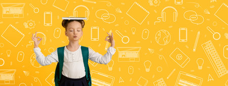 Child Practicing Balance With a Book on Head in Front of Bright School-Themed Backgroundの写真素材