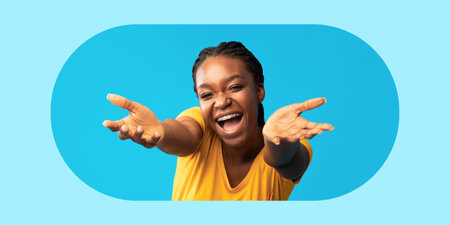 Joyful Woman With Open Arms Expressing Happiness Against a Light Blue Backgroundの写真素材