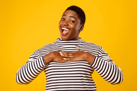 Overweight African American Female Pressing Hands To Chestの写真素材