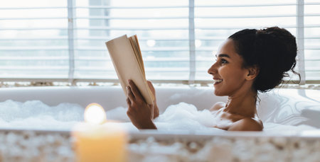 Enjoying a Relaxing Bath While Reading a Book on a Quiet Afternoon at Homeの写真素材