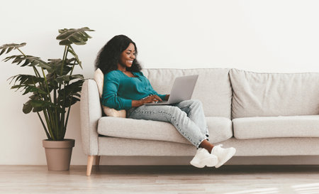 Stylish african american lady independent contractor working from homeの写真素材