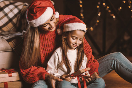 Portrait of happy woman and daughter celebrating new year holidayの写真素材