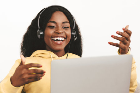 Closeup of cheerful black woman having job video conference