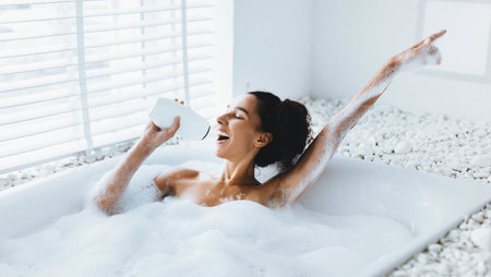 Enjoying a Relaxing Bubble Bath While Sipping a Drink in a Bright Bathroom