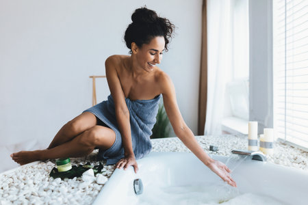 Woman Enjoying a Relaxing Moment in a Modern Bathroom With a Tub and Candlesの写真素材