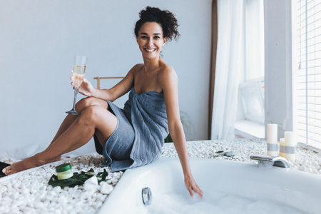 Woman Enjoys a Relaxing Spa Experience in a Modern Bathroom Settingの写真素材