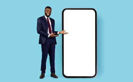Successful Businessman Pointing At Big Smartphone With White Blank Screenの写真素材