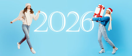 Joyful Women Celebrating the Arrival of 2026 With Gifts and Festive Outfitsの写真素材