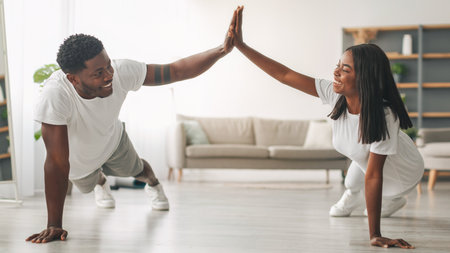 Young black couple planking and giving high five