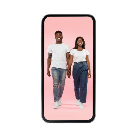 Young Black Couple Joyfully Emerges From a Smartphone Screen on a Pink Background
